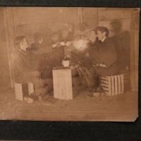 5 Young Men Drinking with Tea Cups By Glowing Lantern Light 1